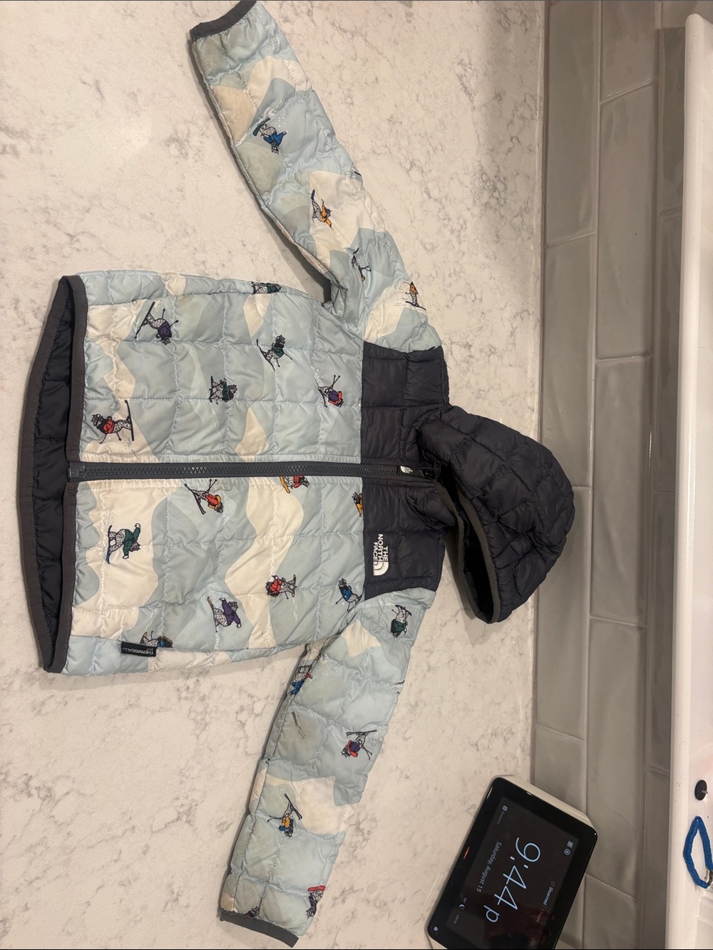 The North Face Kids Light Blue and Black Ski Print Puffer Jacket